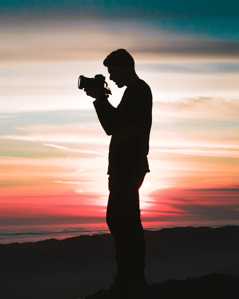 Fotógrafo registrando um momento ao pôr do sol